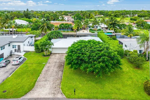 an aerial view of residential houses with outdoor space and street view