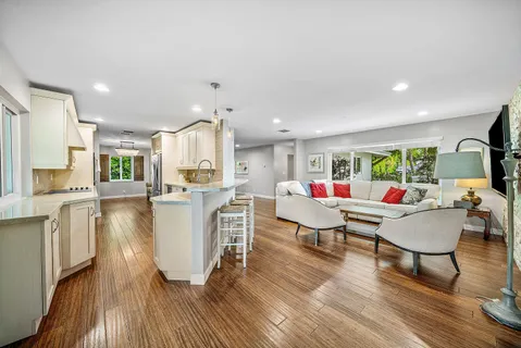 a living room with furniture and a wooden floor