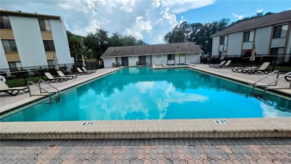 a view of swimming pool with outdoor seating