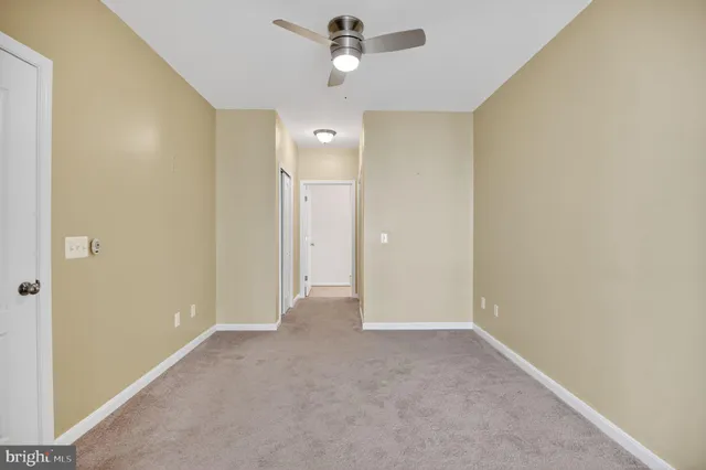 a kitchen with kitchen island granite countertop stainless steel appliances a refrigerator a stove a sink and a center island