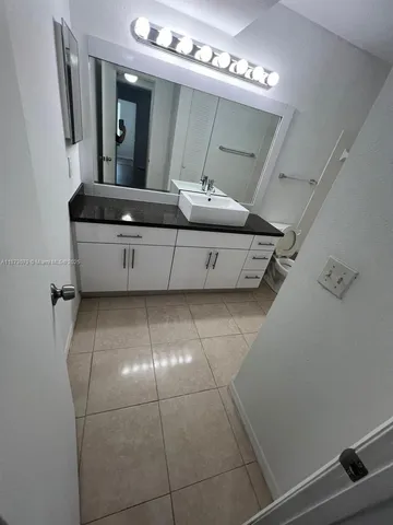 a view of a small space with wooden floor and a window