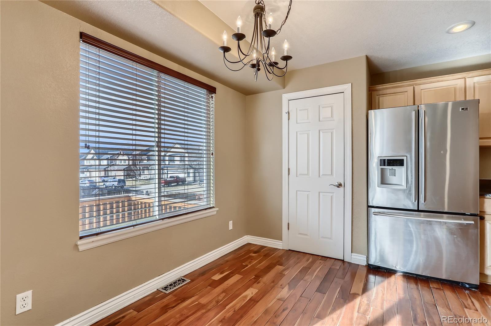 3905 South Kirk Way Aurora, CO 80013 - Photo 11 of 33 a view of livingroom with hardwood floor and hallway