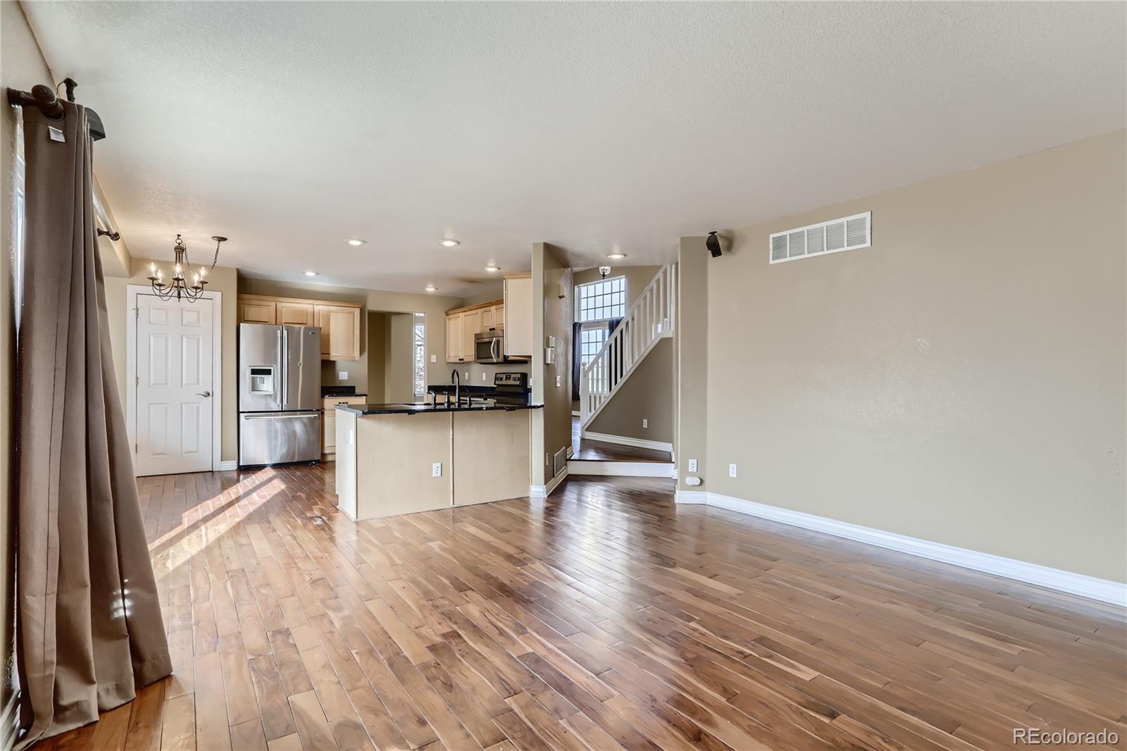 3905 South Kirk Way Aurora, CO 80013 - Photo 12 of 33 a view of a kitchen with a sink and a refrigerator