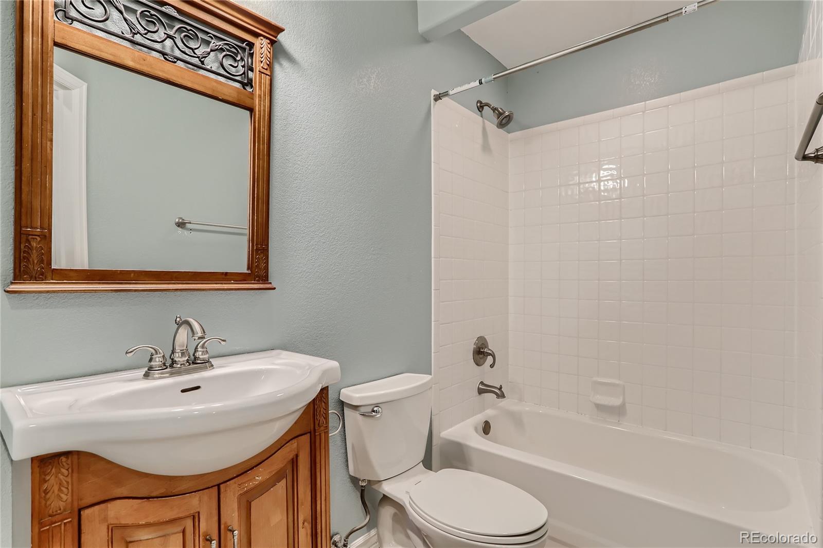 3905 South Kirk Way Aurora, CO 80013 - Photo 25 of 33 a bathroom with a sink toilet and shower