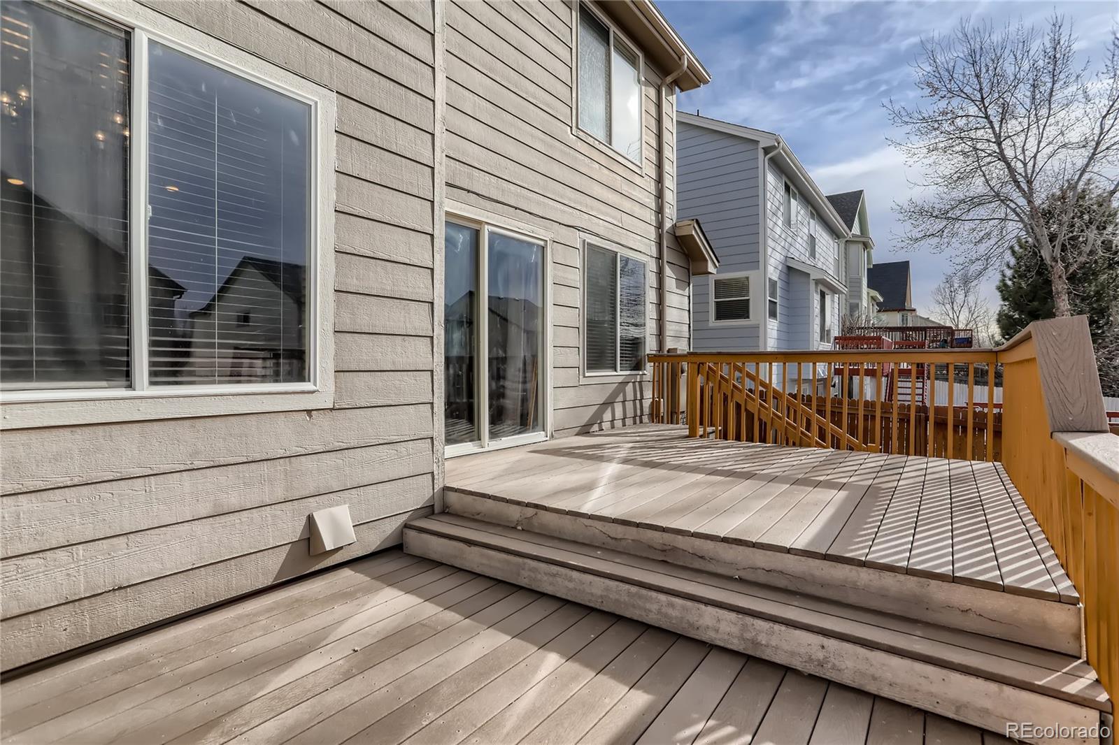 3905 South Kirk Way Aurora, CO 80013 - Photo 29 of 33 a view of a wooden deck with two couches and deck with wooden floor and fence