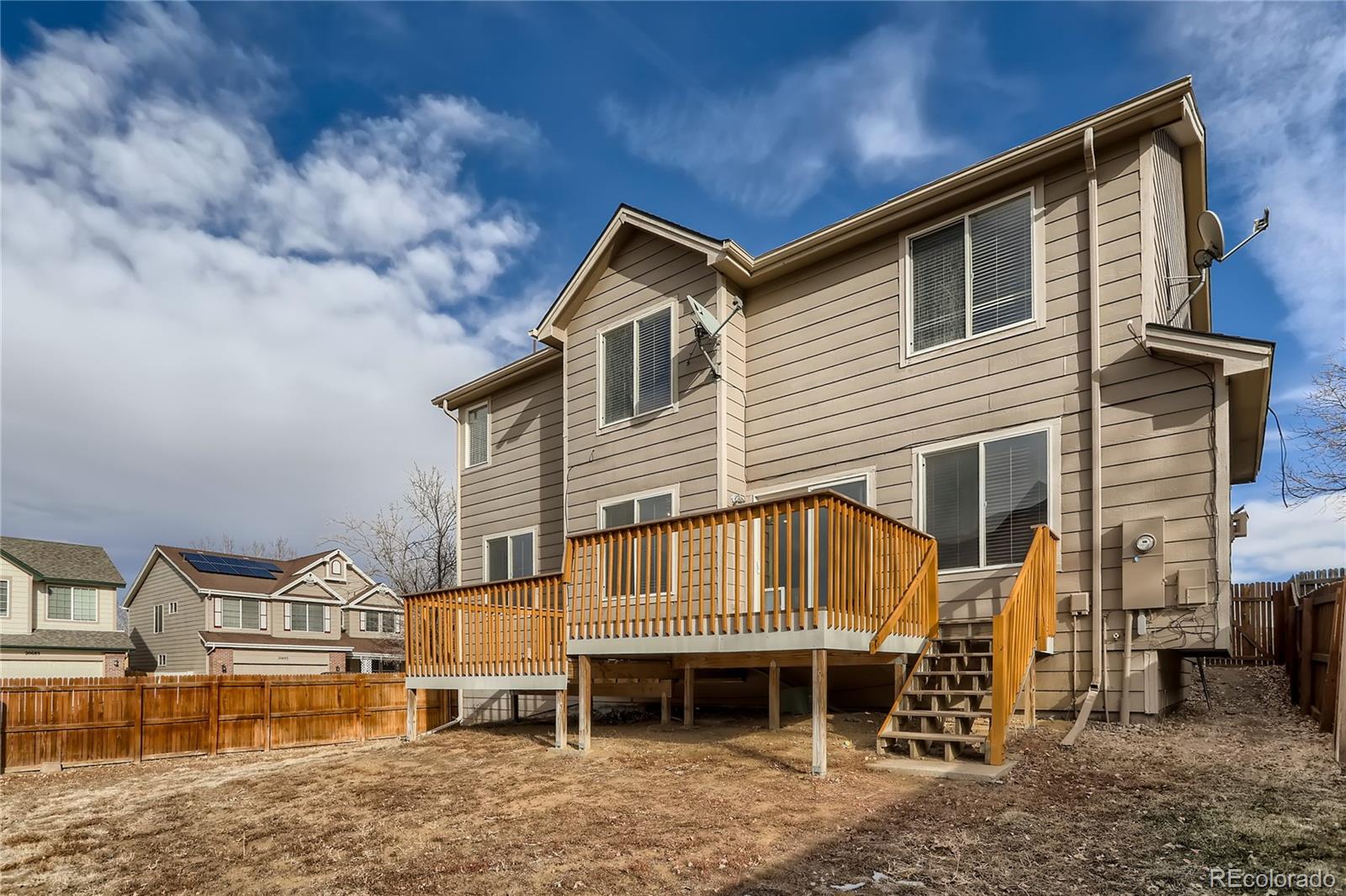 3905 South Kirk Way Aurora, CO 80013 - Photo 31 of 33 a front view of a house with a yard and balcony