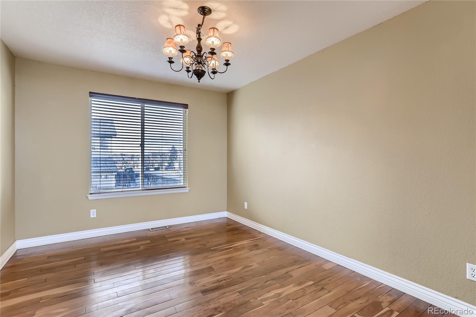 3905 South Kirk Way Aurora, CO 80013 - Photo 6 of 33 a view of empty room with wooden floor and fan