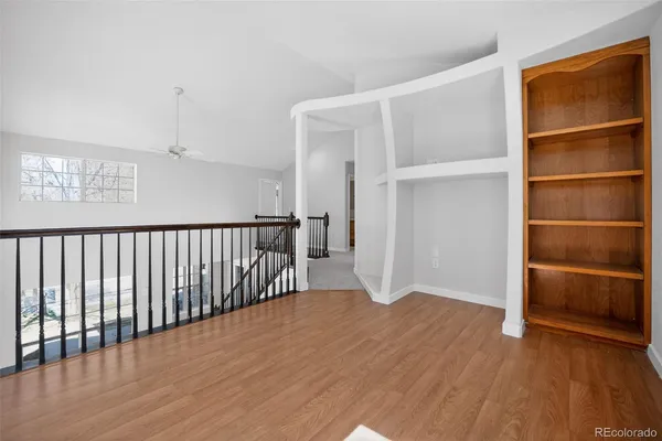 a view of a hallway with wooden floor and closet