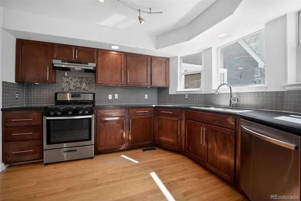 a kitchen with sink a microwave and cabinets