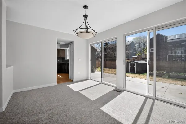 a living room with a large window and a glass door