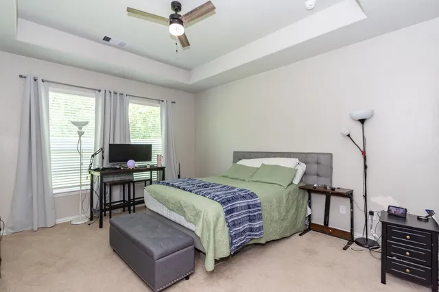 a bedroom with a bed and a desk