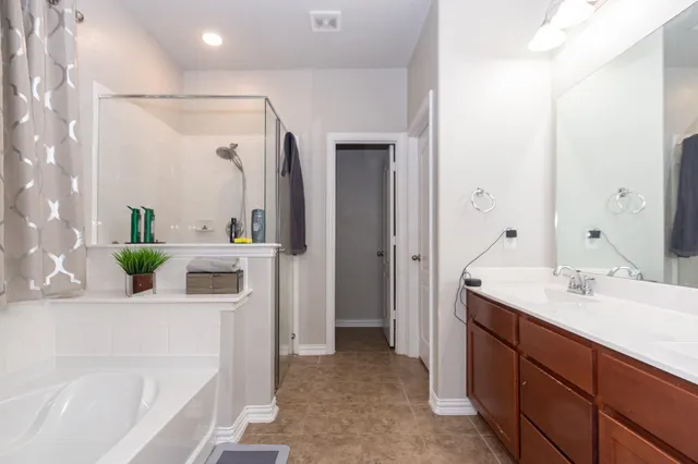 a bathroom with a granite countertop sink mirror and vanity