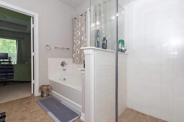 a bathroom with a bathtub and a shower