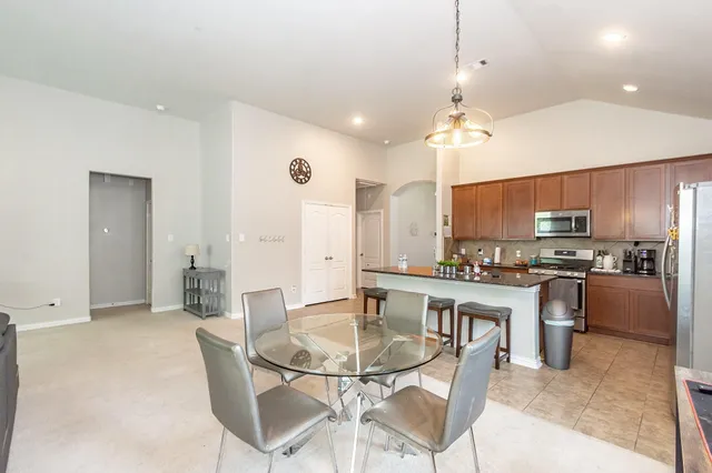 a large kitchen with a table and chairs