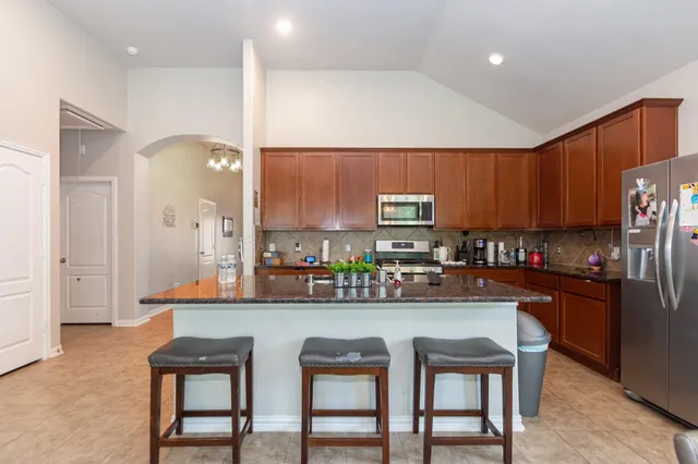 a kitchen with a sink cabinets and window