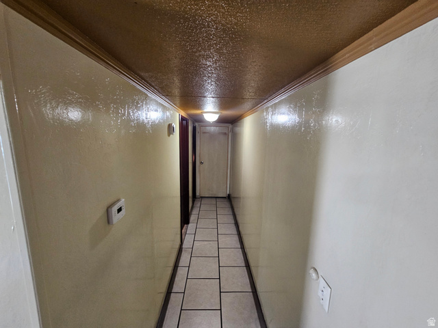 340 West 920 South, Unit 16 Provo, UT 84601 - Photo 14 of 15 Hall featuring tile patterned floors, a textured ceiling, and ornamental molding