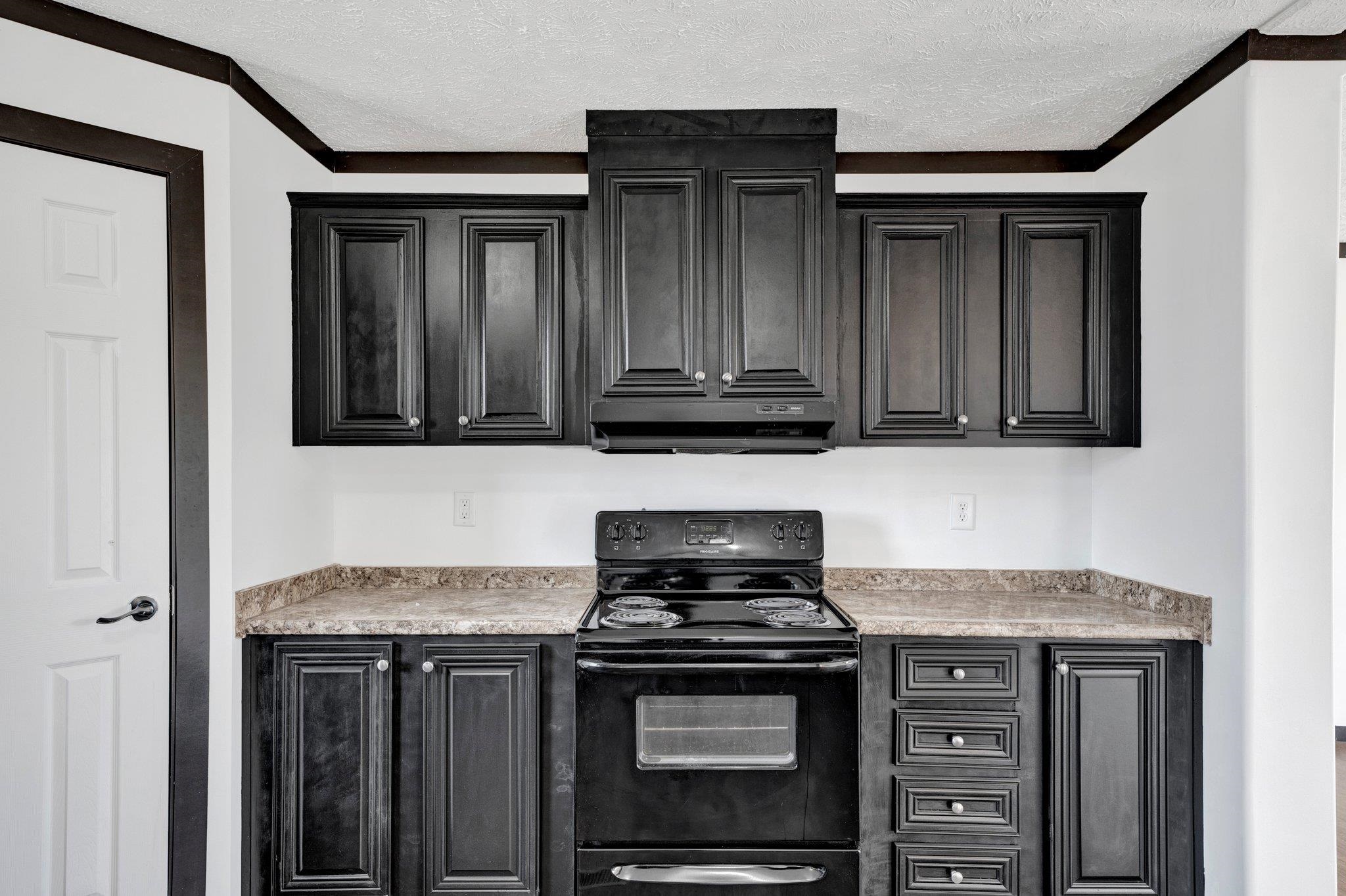 826 Nelson Road Brighton, TN 38011 - Photo 22 of 38 Kitchen with black electric range, exhaust hood, and a textured ceiling