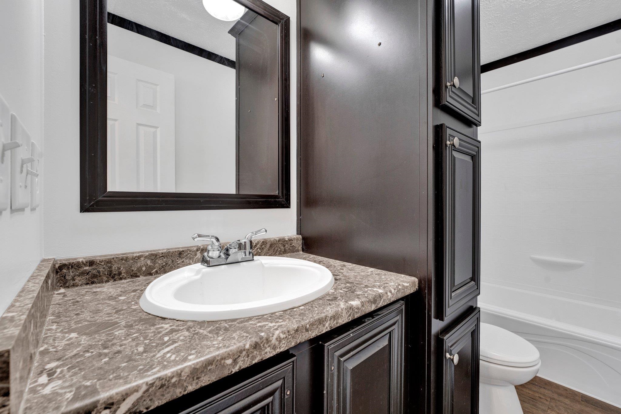 826 Nelson Road Brighton, TN 38011 - Photo 26 of 38 Full bathroom with vanity, a textured ceiling, bathing tub / shower combination, hardwood / wood-style flooring, and toilet