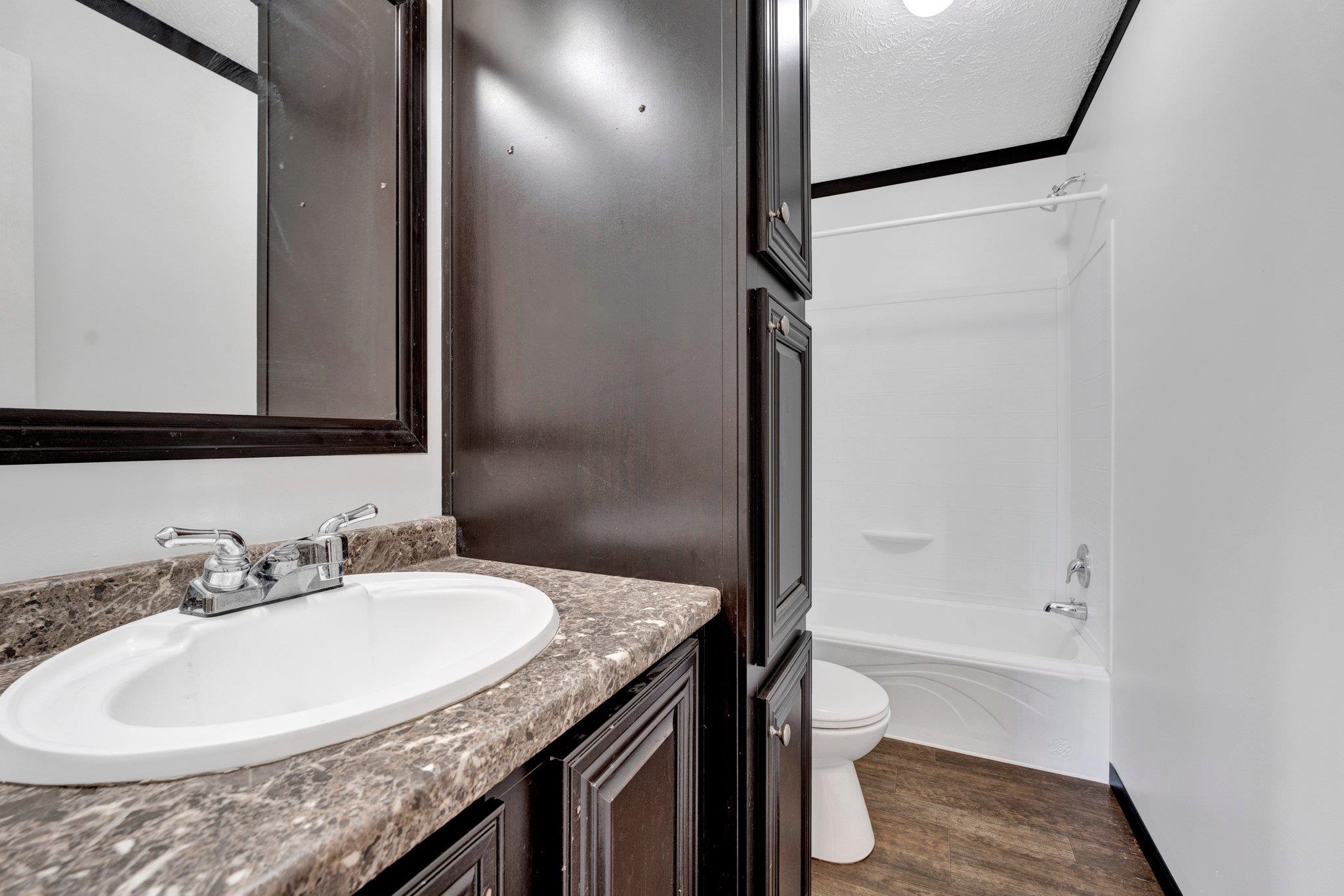 826 Nelson Road Brighton, TN 38011 - Photo 27 of 38 Full bathroom with shower / bath combination, wood-type flooring, a textured ceiling, toilet, and vanity