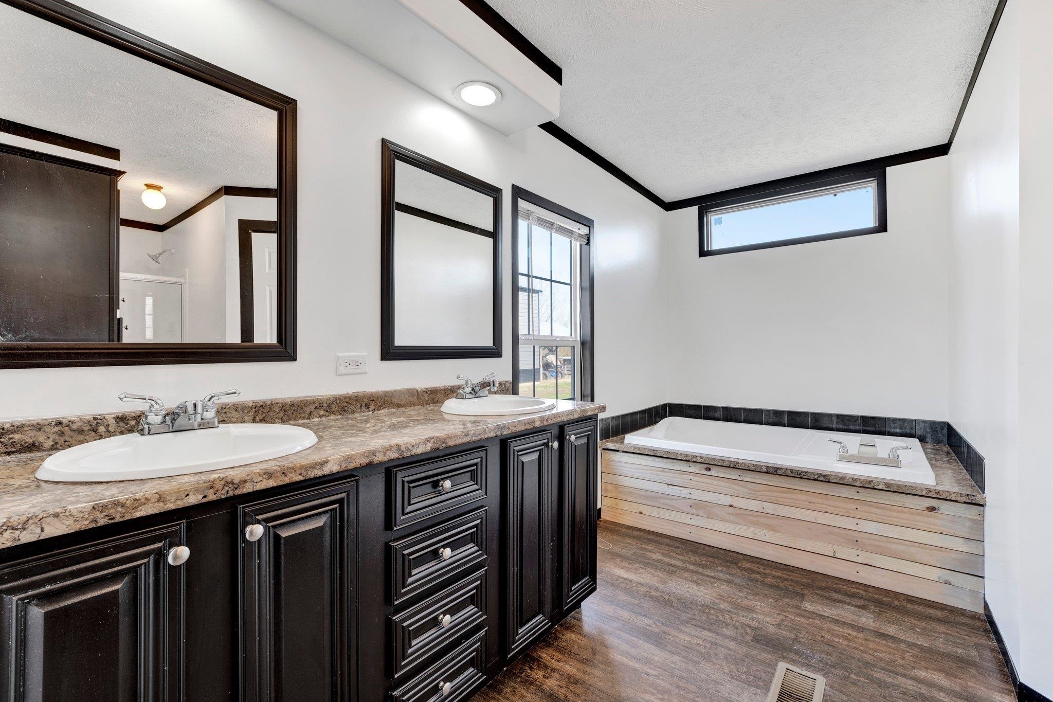 826 Nelson Road Brighton, TN 38011 - Photo 30 of 38 Bathroom with vanity, hardwood / wood-style flooring, ornamental molding, a textured ceiling, and a tub