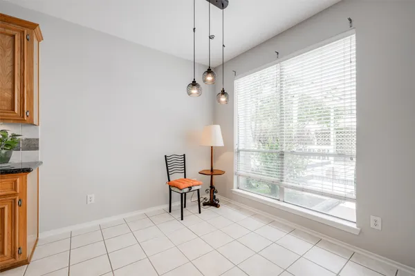 a dining room with furniture and a window