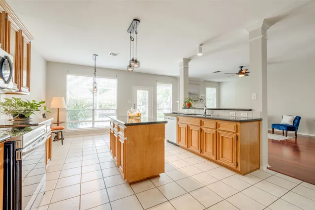 a kitchen with stainless steel appliances granite countertop a stove a sink and a refrigerator