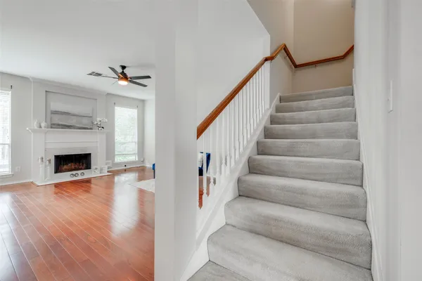 a view of a livingroom with wooden floor and a fireplace