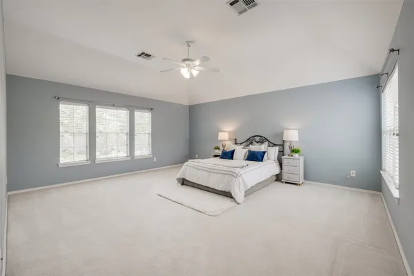 a spacious bedroom with a bed and window