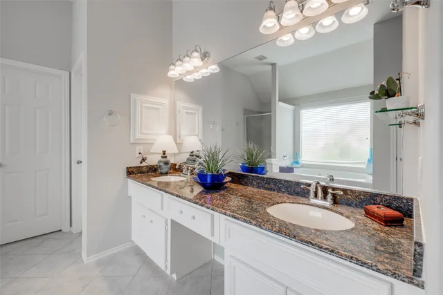 a bathroom with double sink and a mirror