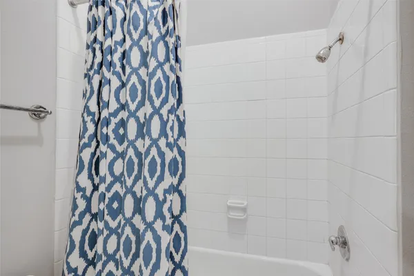 a bathroom with a bathtub and a shower curtain