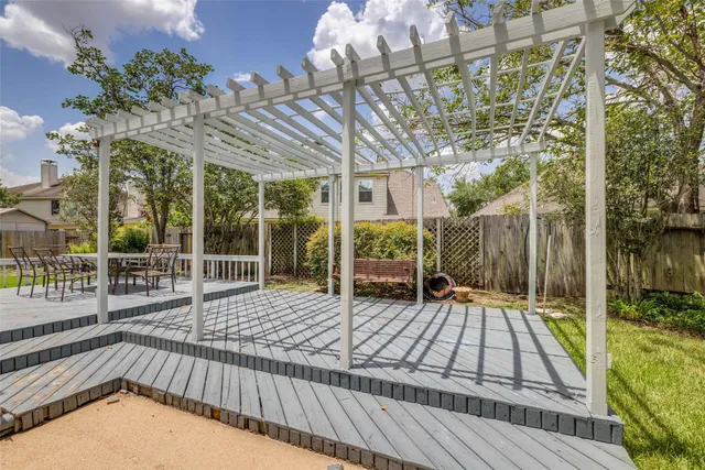 a view of a patio with a table and chairs