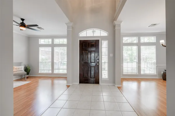a view of an entryway with wooden floor and a living room