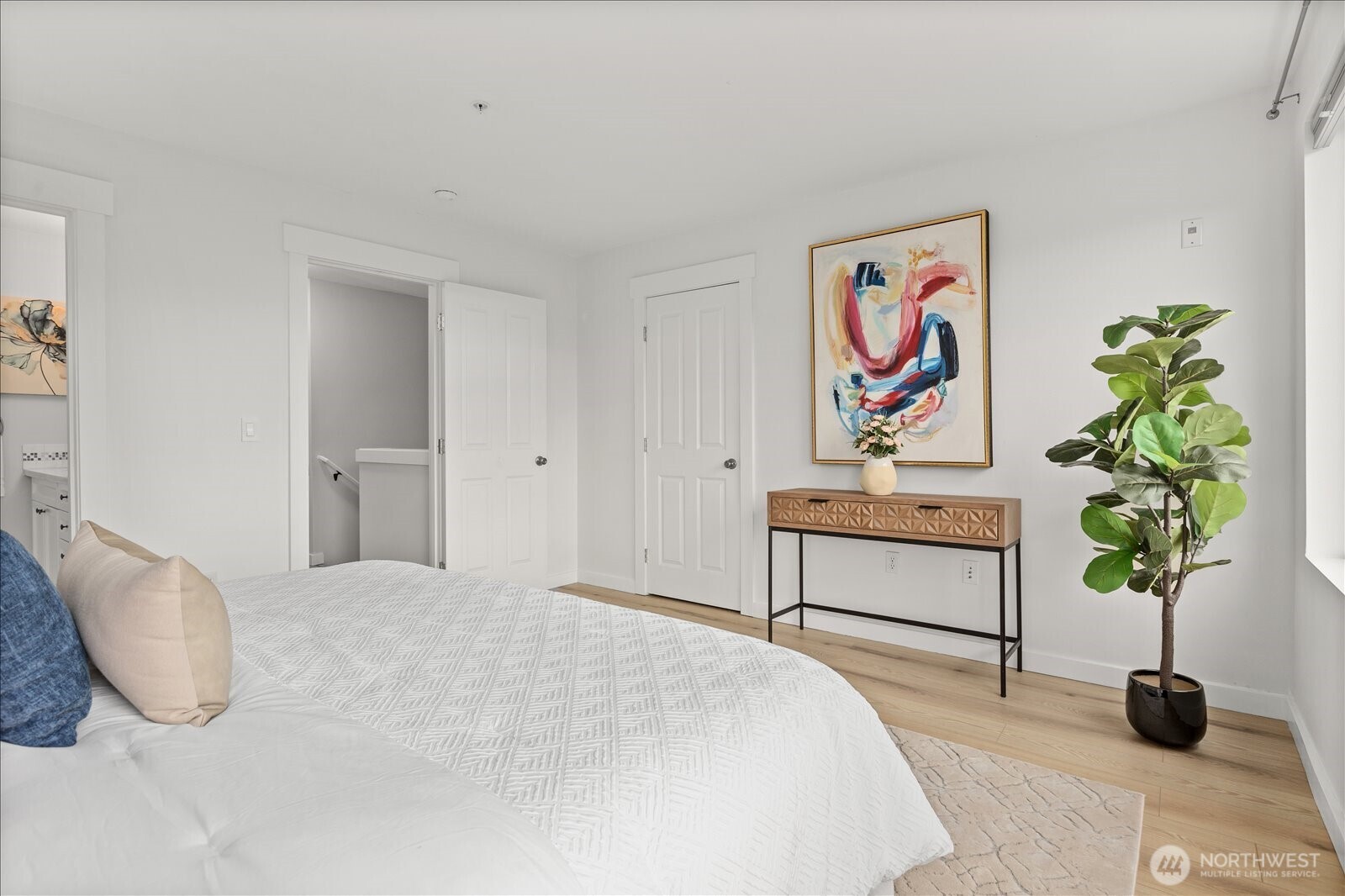 23300 Southeast Black Nugget Road, Unit D3 Issaquah, WA 98029 - Photo 22 of 35 a bedroom with a bed and a potted plant