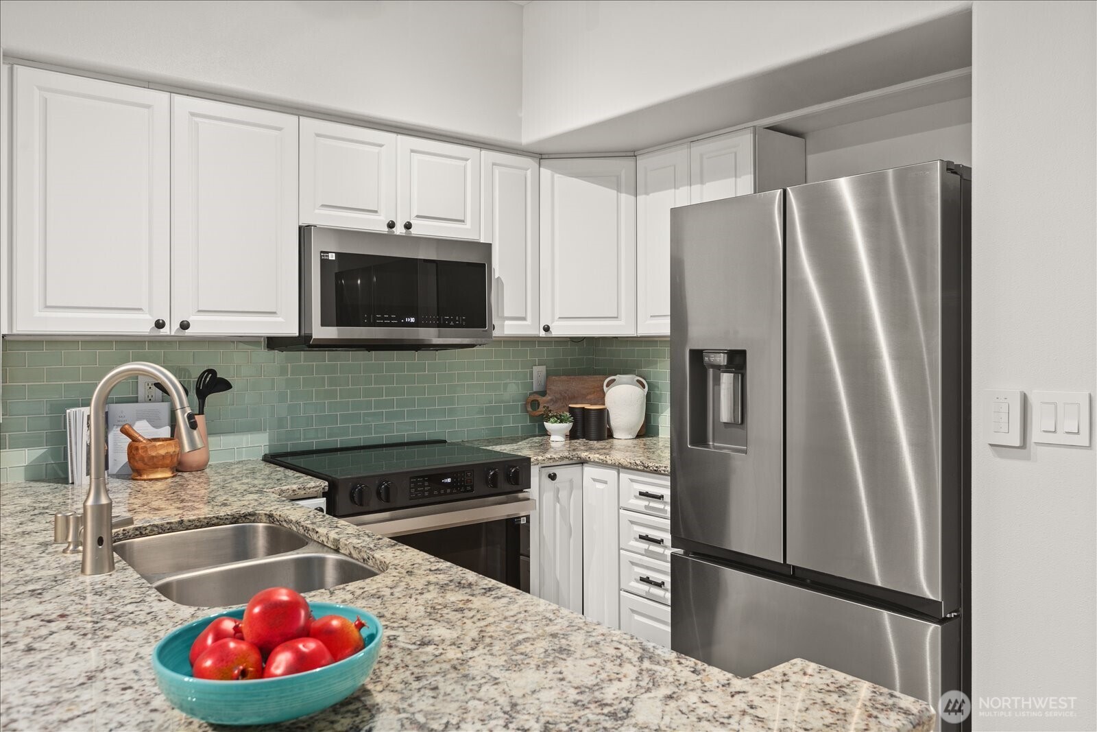 23300 Southeast Black Nugget Road, Unit D3 Issaquah, WA 98029 - Photo 7 of 35 a kitchen with stainless steel appliances granite countertop a refrigerator sink and stove