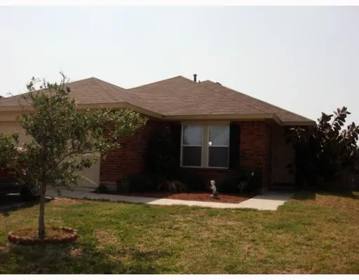 a front view of house with yard and trees