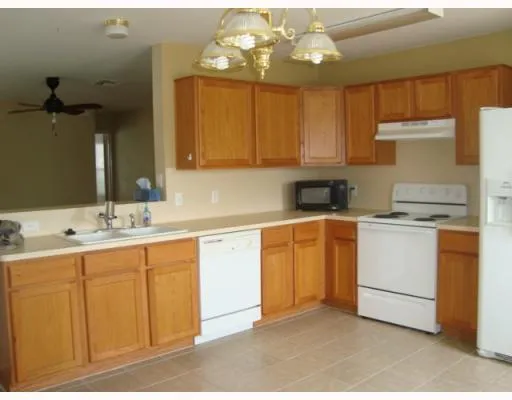 a kitchen with a sink cabinets and window