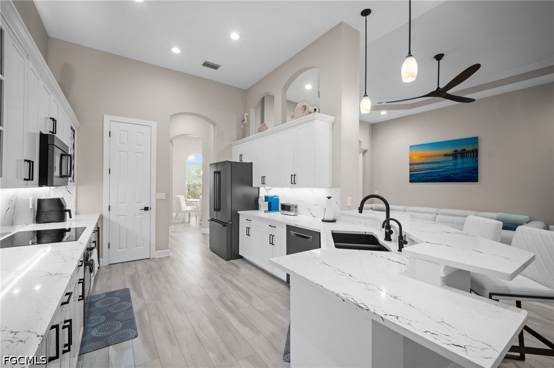 9042 Bronco Court Naples, FL 34113 - Photo 8 of 50 a large kitchen with a table chairs refrigerator and a sink