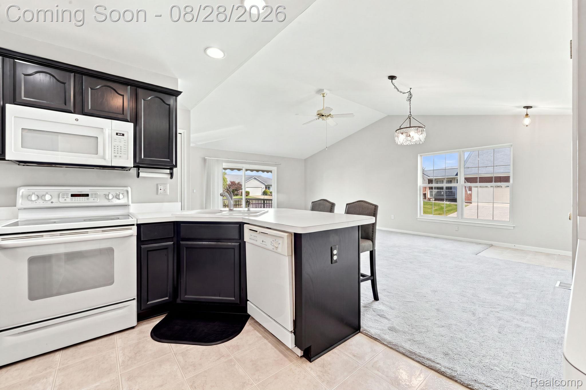 493 Harvard Drive Romeo, MI 48065 - Photo 11 of 36 Kitchen featuring dark cabinetry, white countertops, and white appliances
