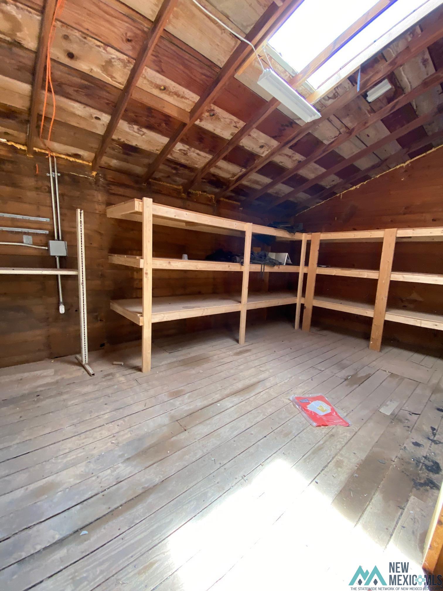 1131 Curry Road North Clovis, NM 88101 - Photo 65 of 69 Interior storage space featuring exposed wood beam ceiling and plank flooring