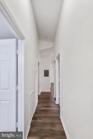 a view of a hallway with a wooden door