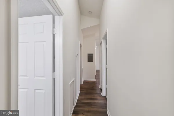 a view of a hallway with wooden floor and staircase