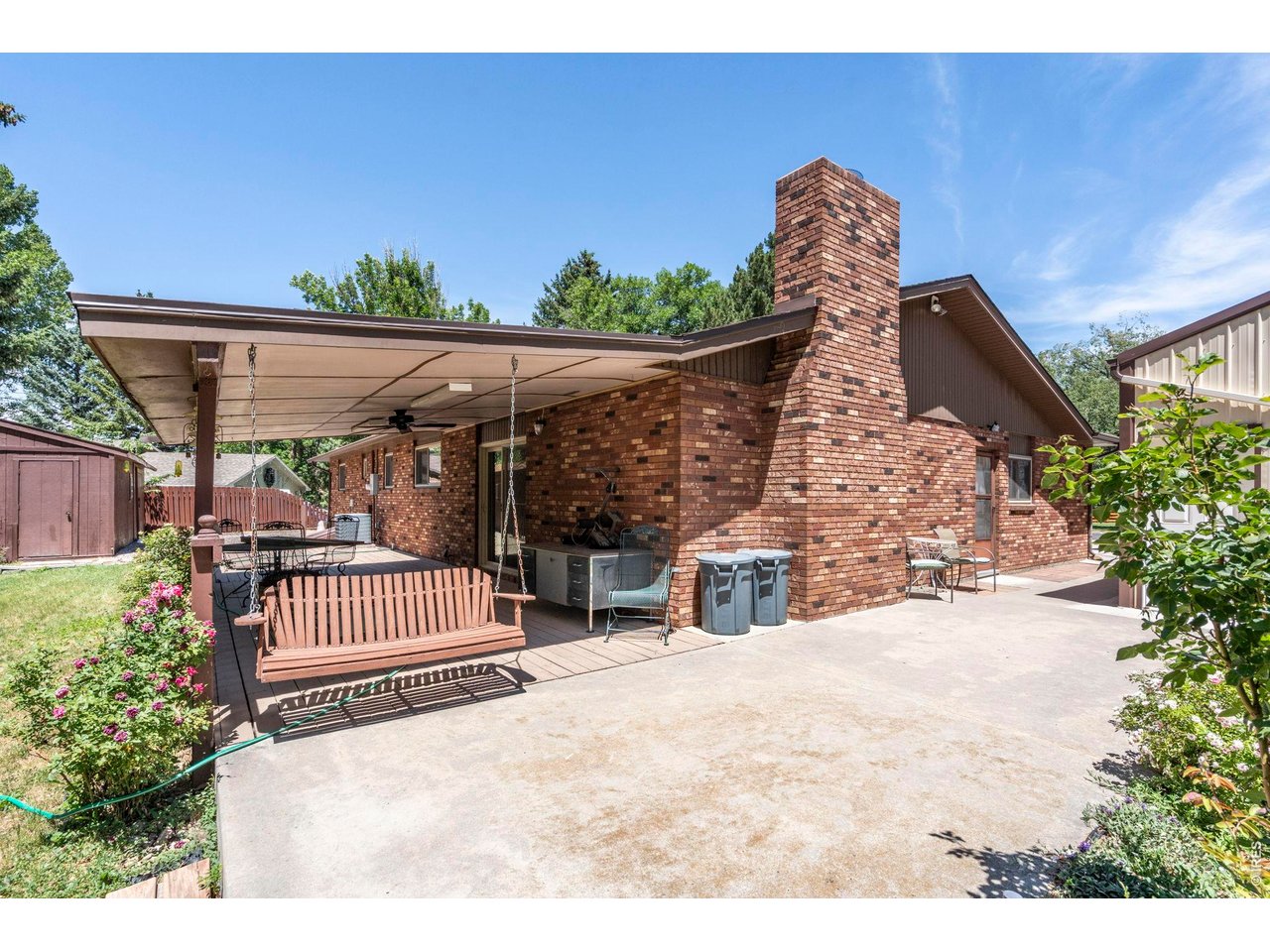 300 Ranch Acres Drive Loveland, CO 80538 - Photo 33 of 38 a view of a porch with a garden