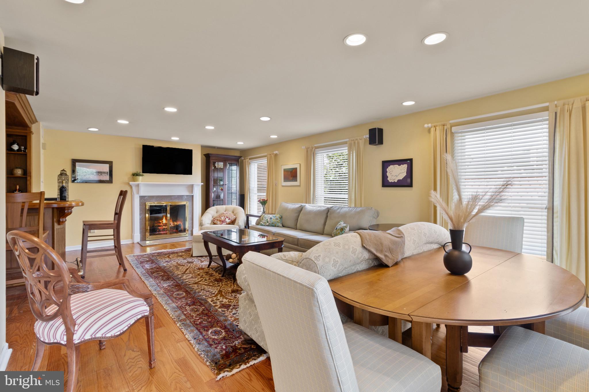 133 Plum Street Moorestown, NJ 08057 - Photo 22 of 54 a living room with furniture a fireplace a flat screen tv and a large window