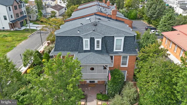 an aerial view of multiple houses with a yard