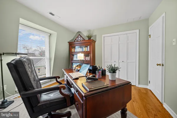 a view of a workspace with furniture and a window