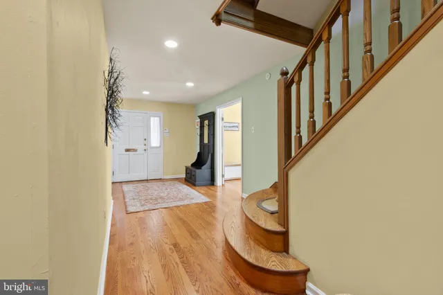 a view of entryway and hall with wooden floor