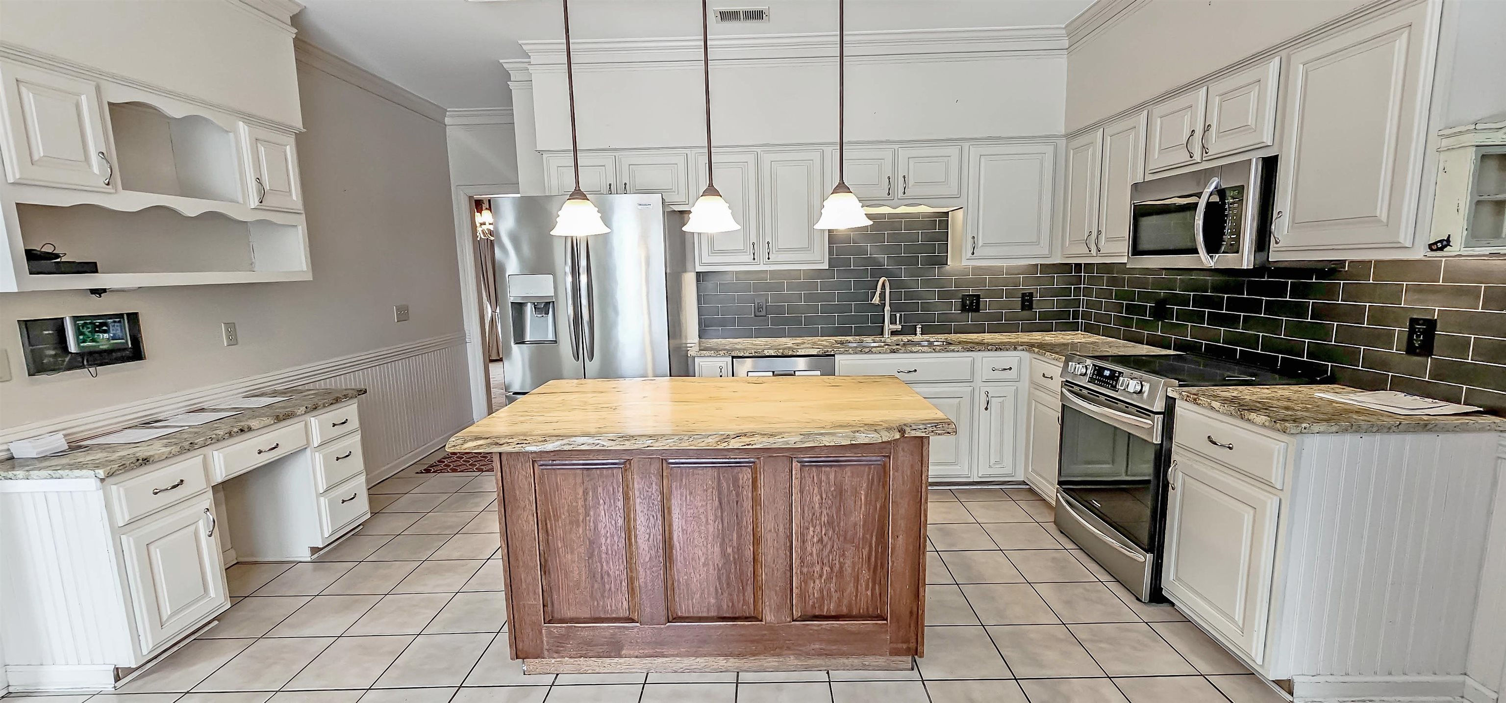 660 Weston Drive Collierville, TN 38017 - Photo 8 of 32 a kitchen with stainless steel appliances granite countertop a sink and cabinets
