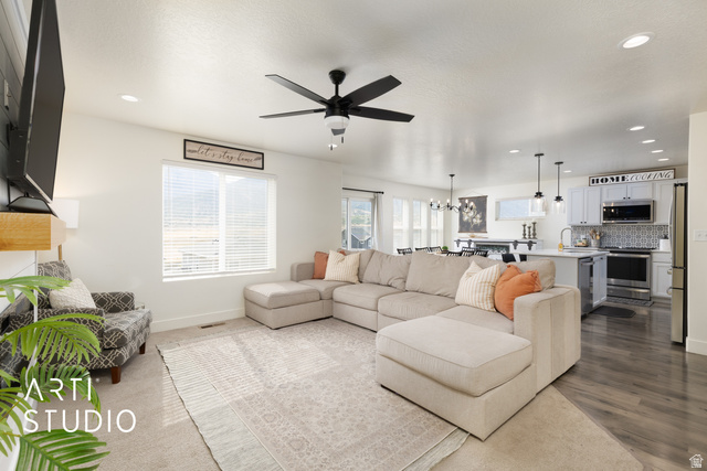 1713 South Windemere Road Santaquin, UT 84655 - Photo 6 of 40 Open-concept living area featuring light-toned walls, recessed lighting, a ceiling fan, and wood-finish flooring