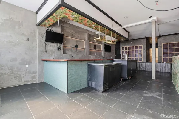 a room with lots of wooden furniture and a sink