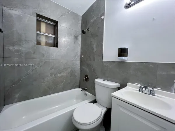 a bathroom with a sink a toilet and a bathtub